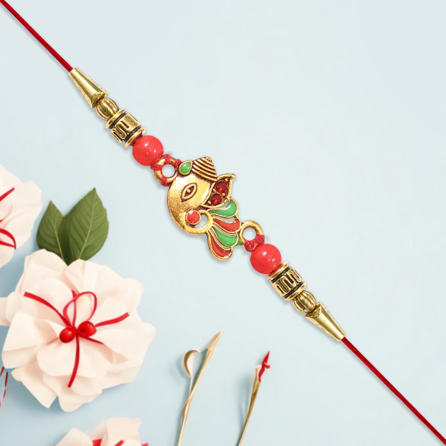 Close-up of handcrafted Ganpati Rakhi highlighting detailed craftsmanship.