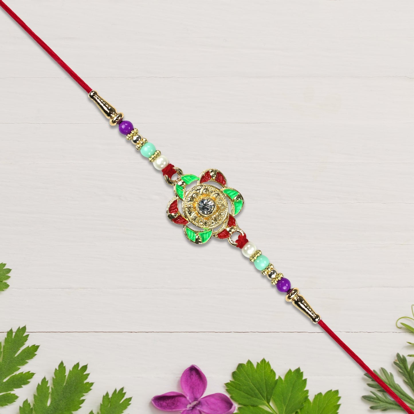 Beautiful gold floral Rakhi with traditional motifs