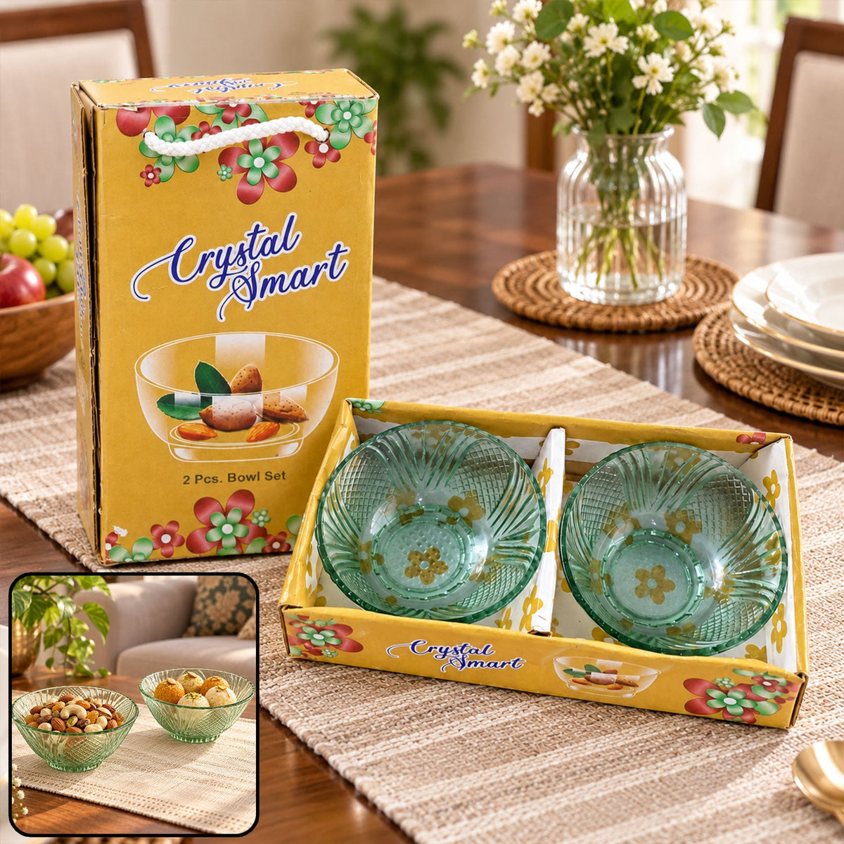 Two green glass bowls in a yellow box, with a vase of flowers and fruit on a wooden table. A smaller inset shows the bowls
