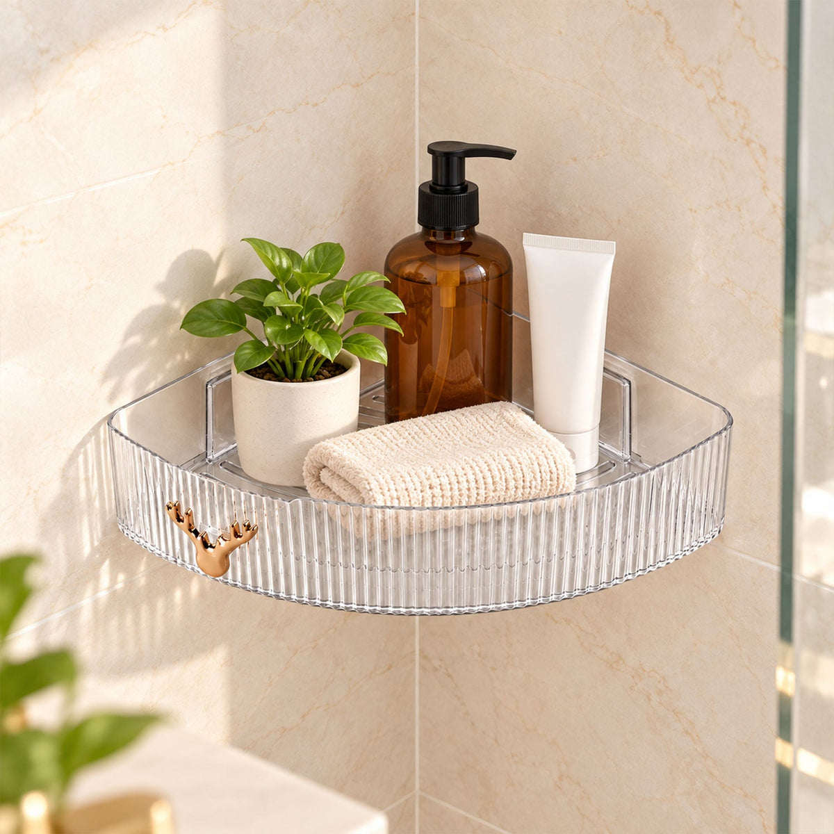 Clear ribbed corner shelf holding a small plant, amber bottle, folded towel, and white tube on a tiled wall.