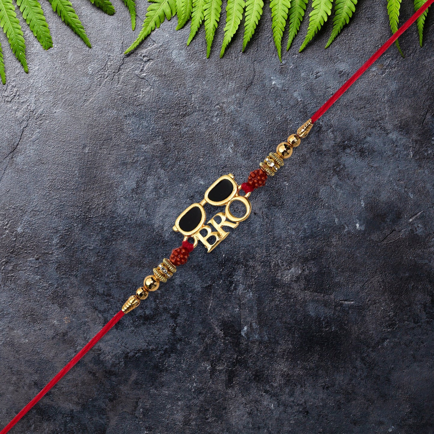 Bro Rakhi with sunglasses design tied elegantly on a brother's wrist symbolizing love.
