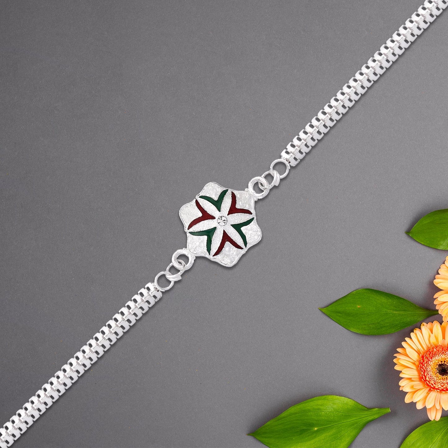 Detail of silver-toned chain linking the flower design of the Rakhi