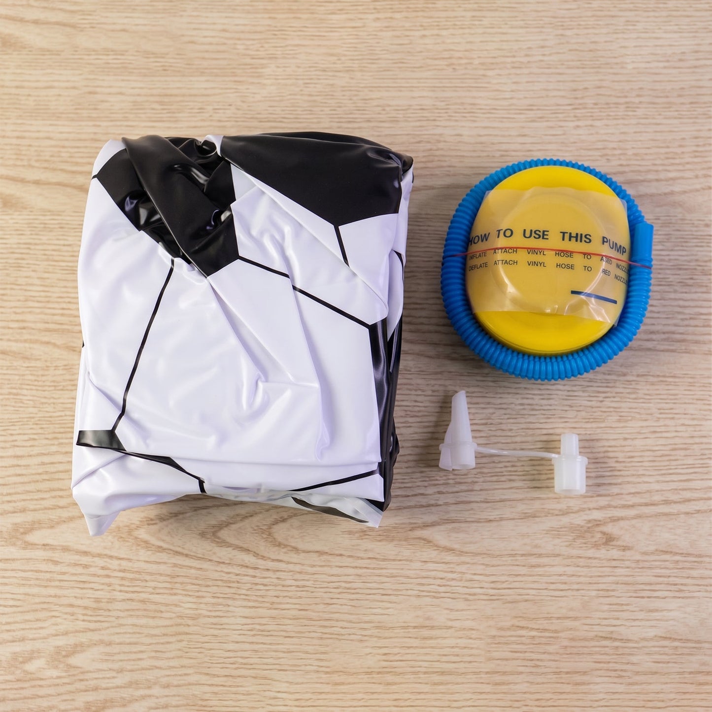 Inflatable soccer ball lounge chair with pump included for quick setup