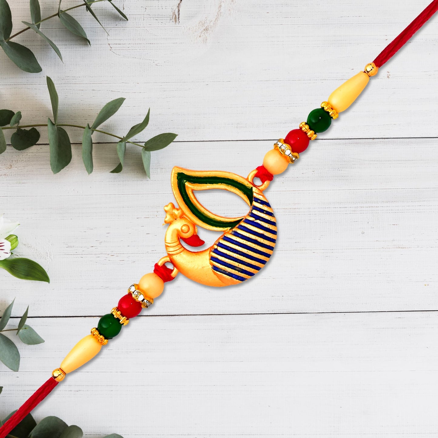 Close-up of Peacock Feather Rakhi beadwork highlighting handmade craftsmanship.