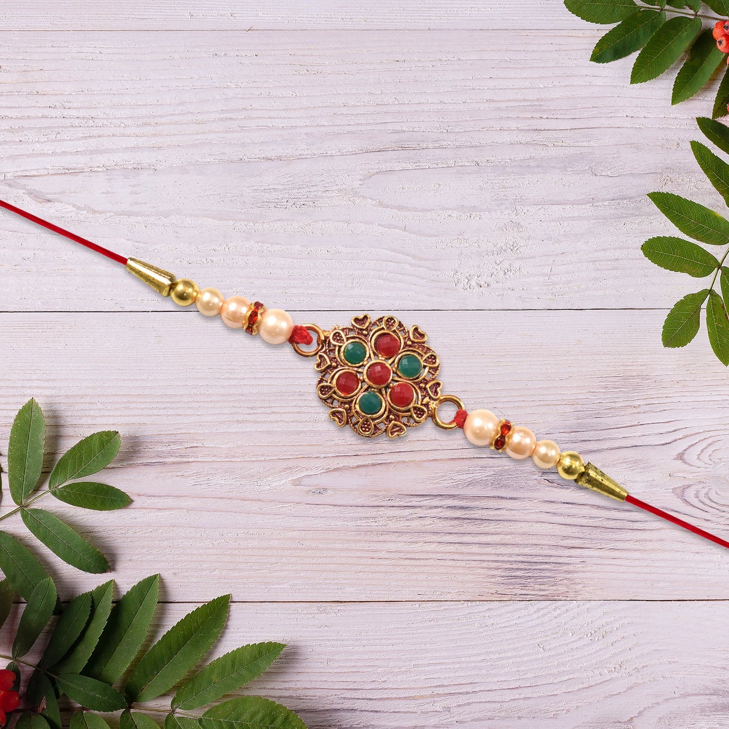 Elegant designer Rakhi featuring colorful beads and traditional floral meenakari centerpiece