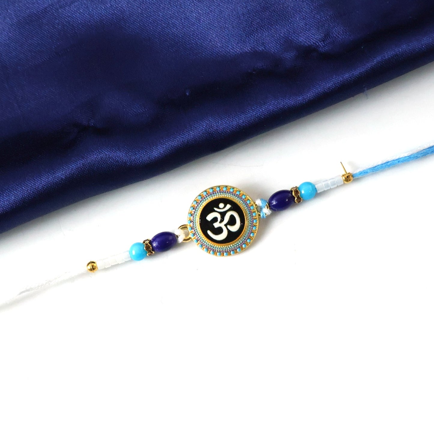 Decorative beads embellishing Om Rakhi's design