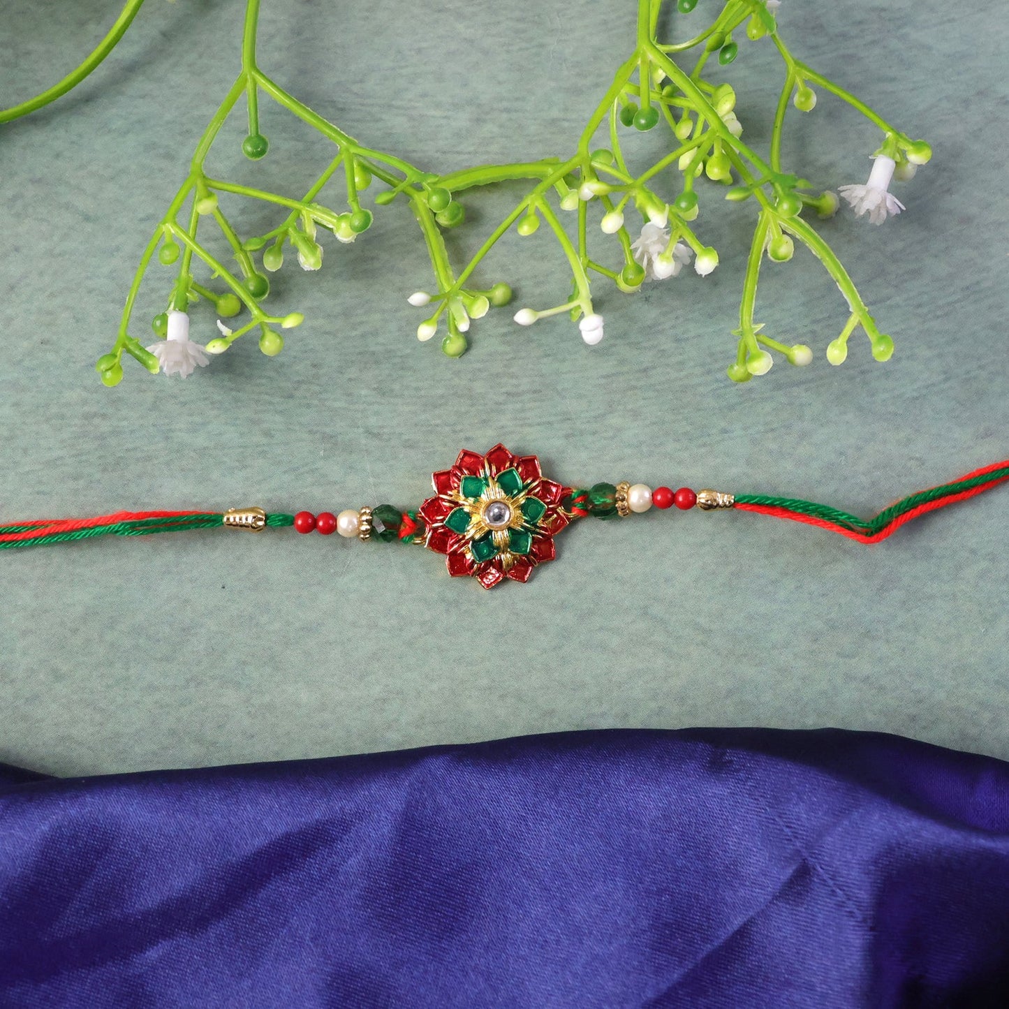 Festive floral stone Rakhi with intricate thread design