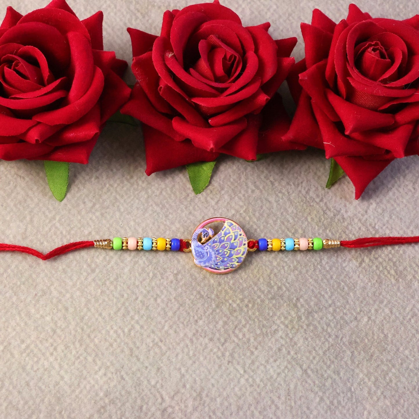 Detailed view of multicolor beads on Peacock Rakhi