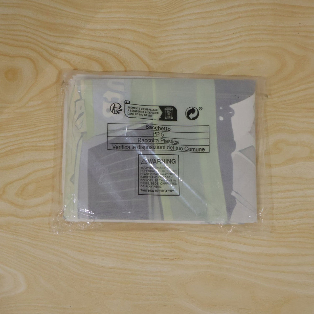 Folded cartoon racing car backdrop in clear plastic packaging