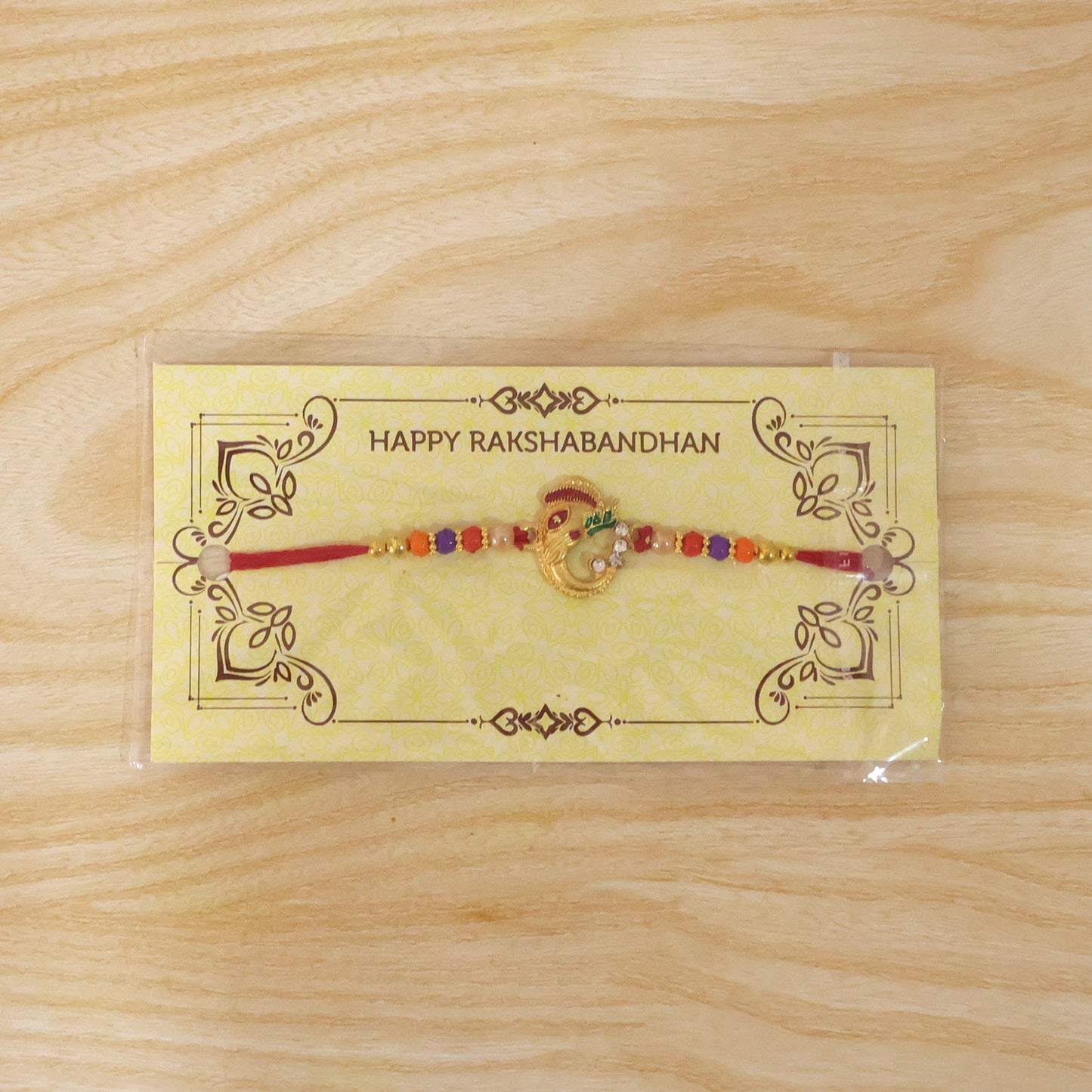 Full view of traditional Ganesh Rakhi with beads and design