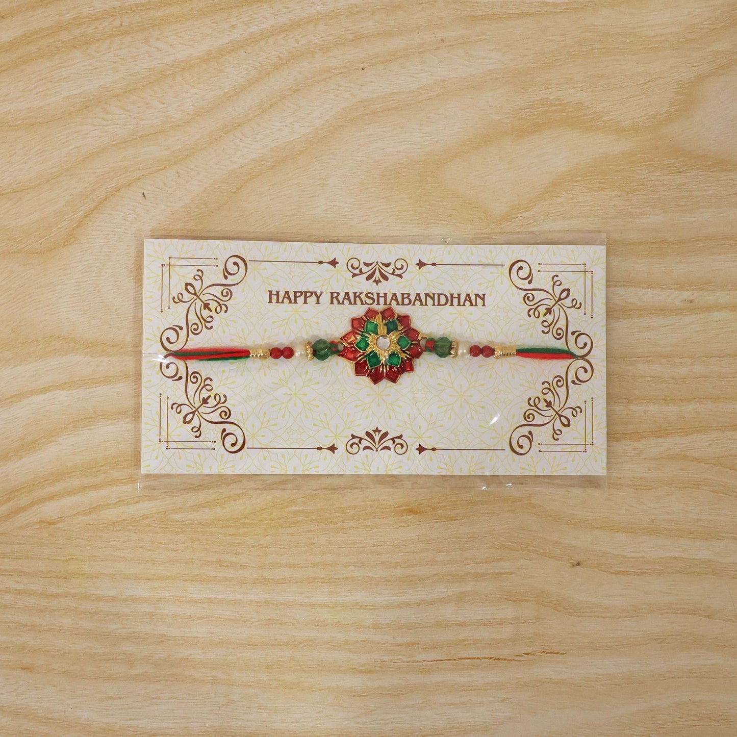 Traditional floral stone centerpiece Rakhi with red and green thread