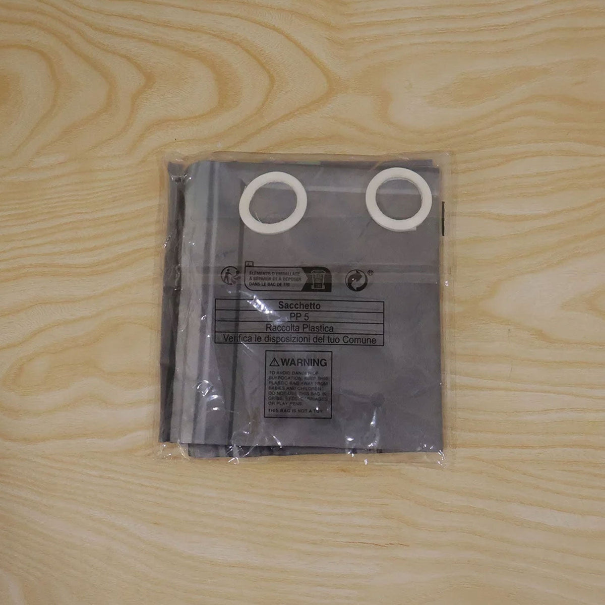 Mardi Gras backdrop in clear packaging showing reinforced edge grommets