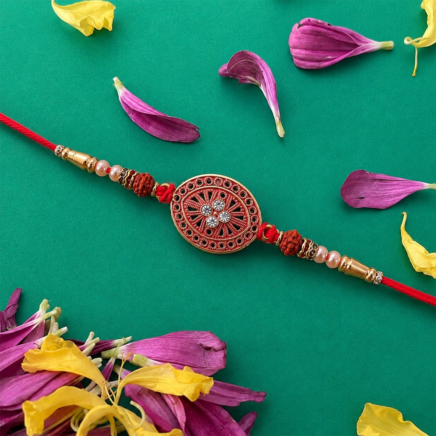 Close-up of red chakra Rakhi with intricate golden beads