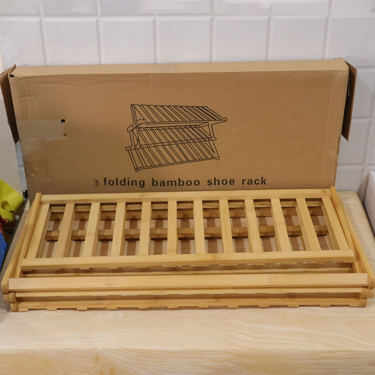 Foldable three layer bamboo storage rack - actual product and brown box