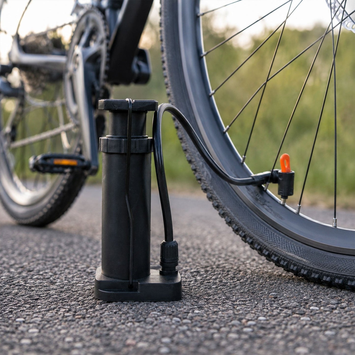 Mini foot pump inflating a football and bicycle tire