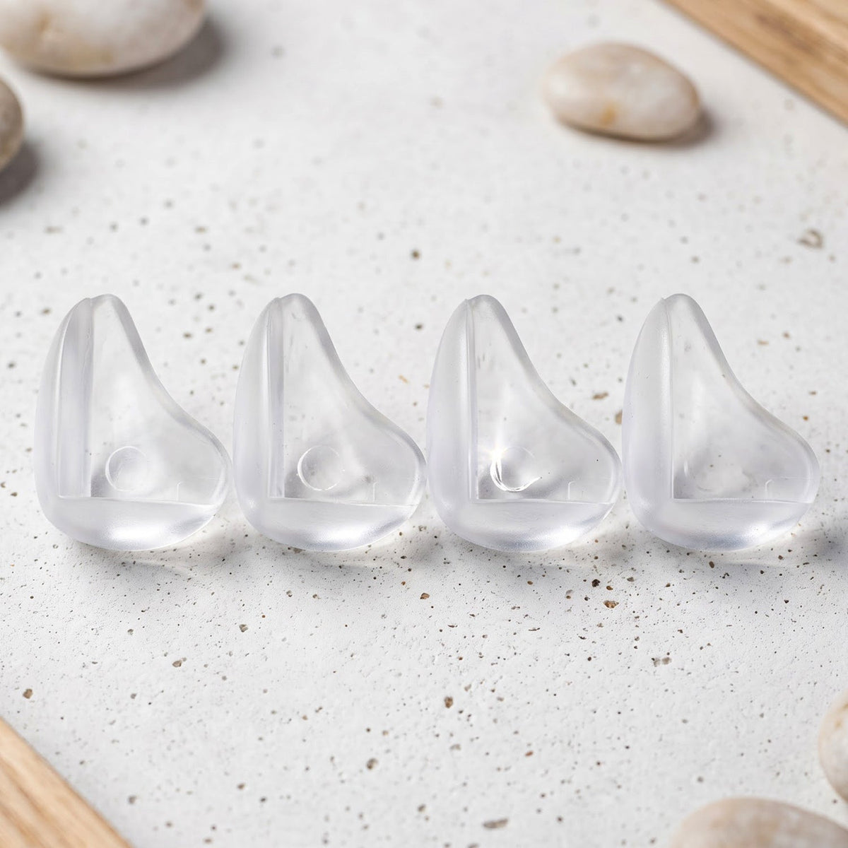 Four transparent table corner protectors