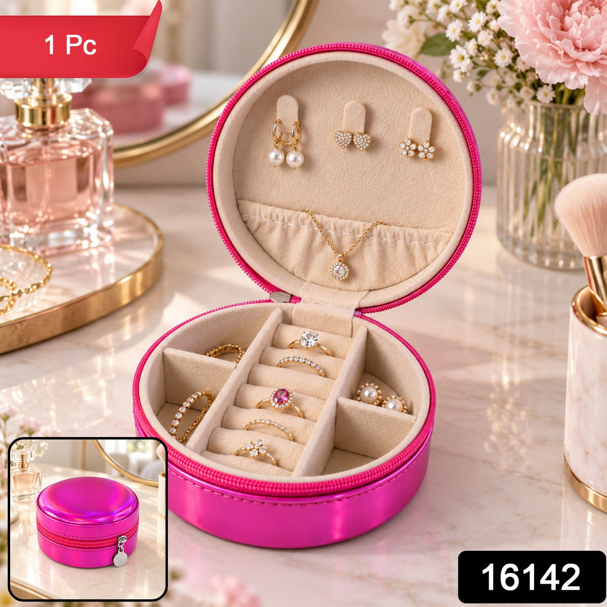 Open round hot pink travel jewellery case with a variety of rings, earrings, and a gold necklace inside.