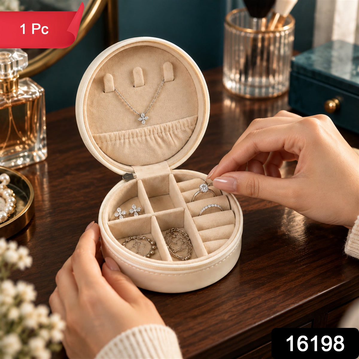 A person's hands placing a silver ring with a clear stone into a cream-colored round jewellery box with a red "1 Pc" label.