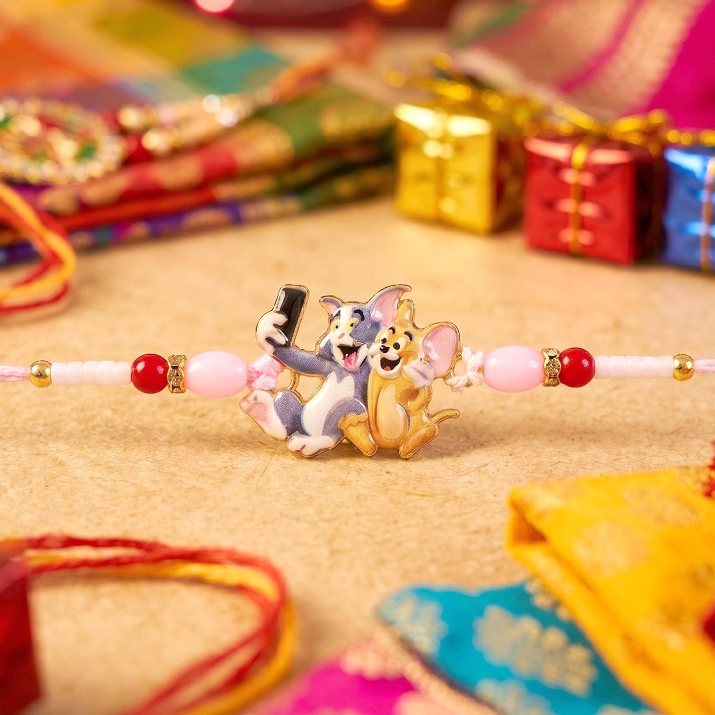 Colorful Kids Rakhi with playful cartoon cat and mouse design