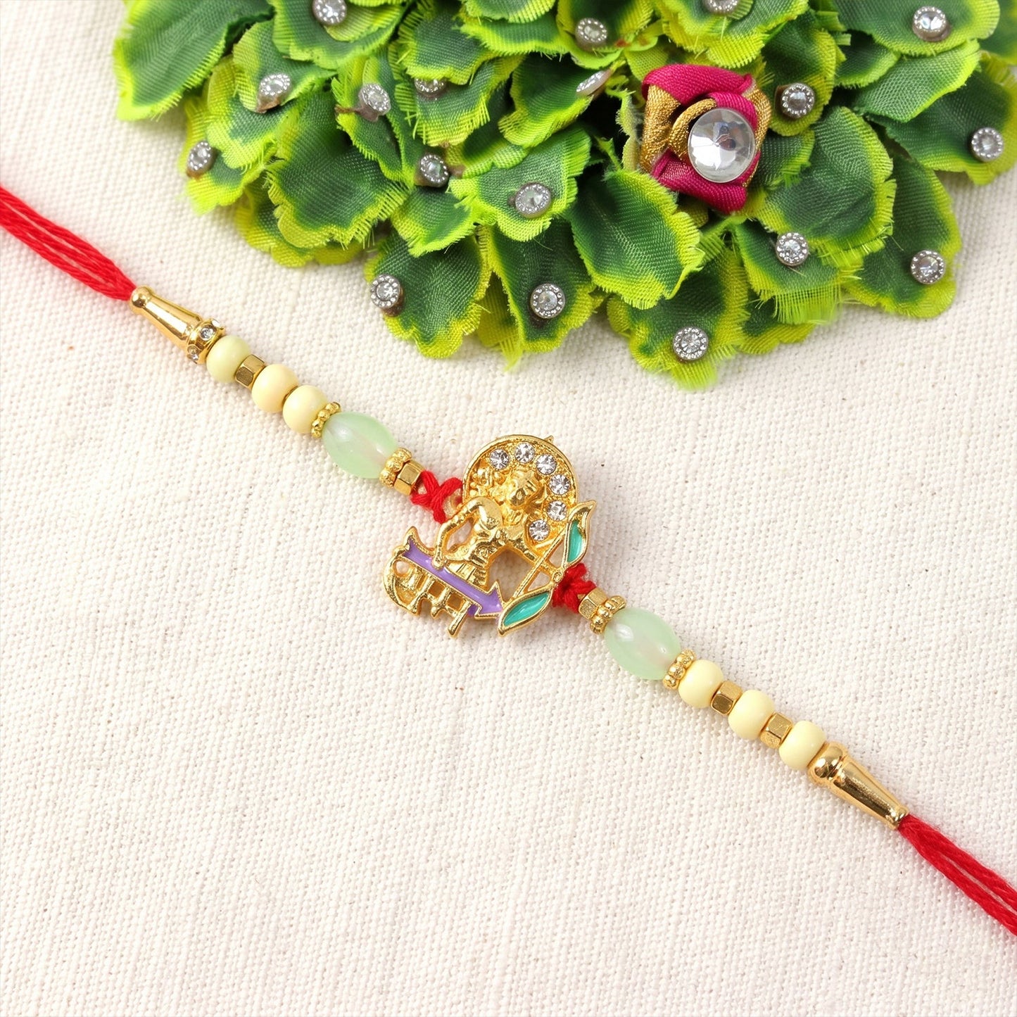 Gold Finish Lord Ram Rakhi with decorative beads on soft thread