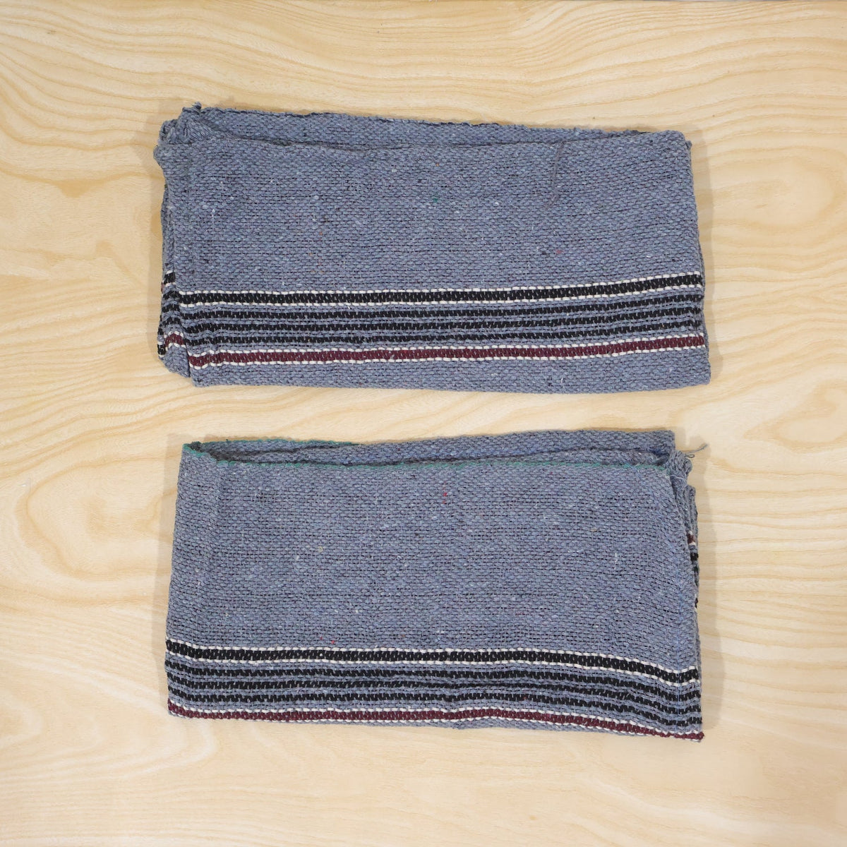 Actual photograph of two folded floor cleaning cloths