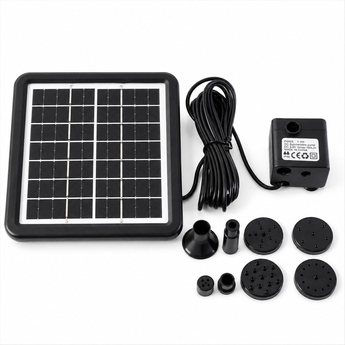 A black solar panel, pump, coiled wire, and multiple fountain nozzles are neatly arranged on a white surface.