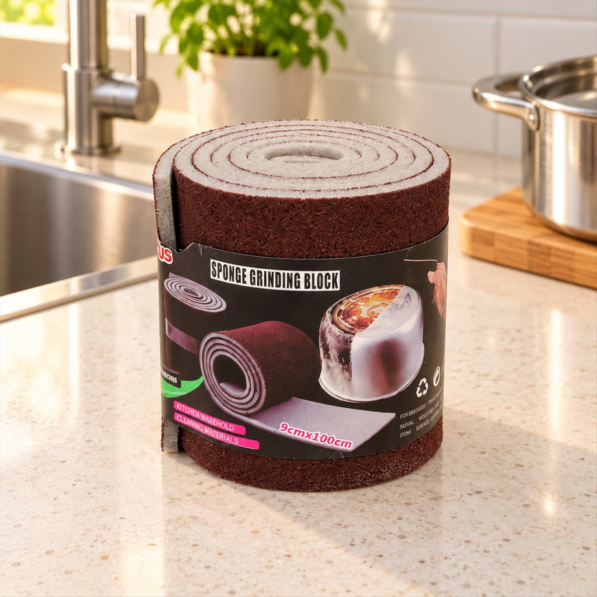 A rolled-up brown abrasive sponge with a label on a kitchen counter next to a sink and pot.