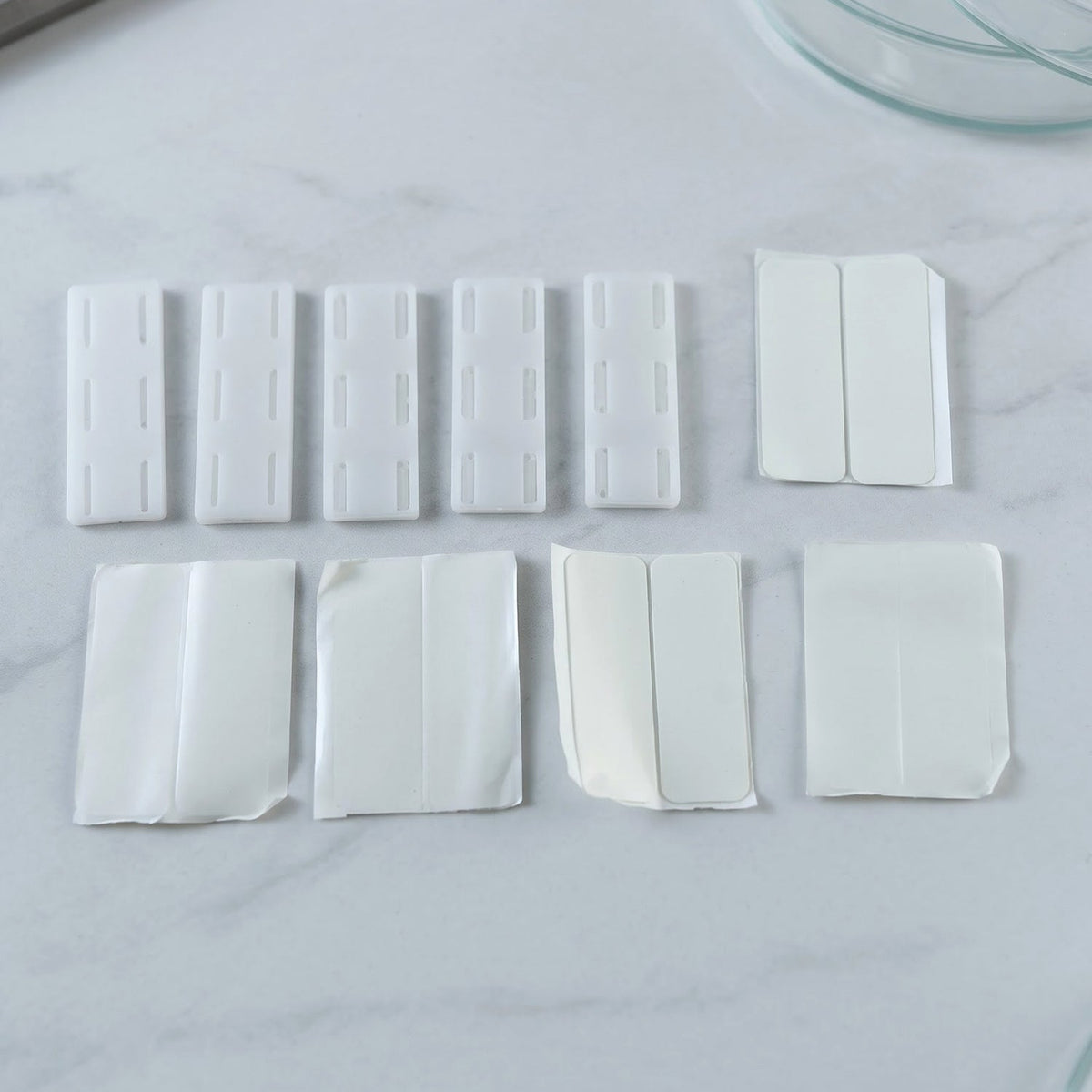 Plastic holder clips with adhesive pads