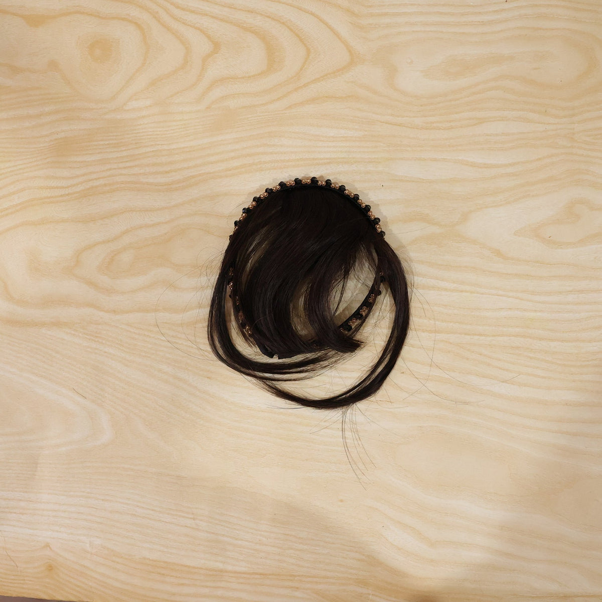 Detailed view of the synthetic fibers and secure clip on hair bangs headband