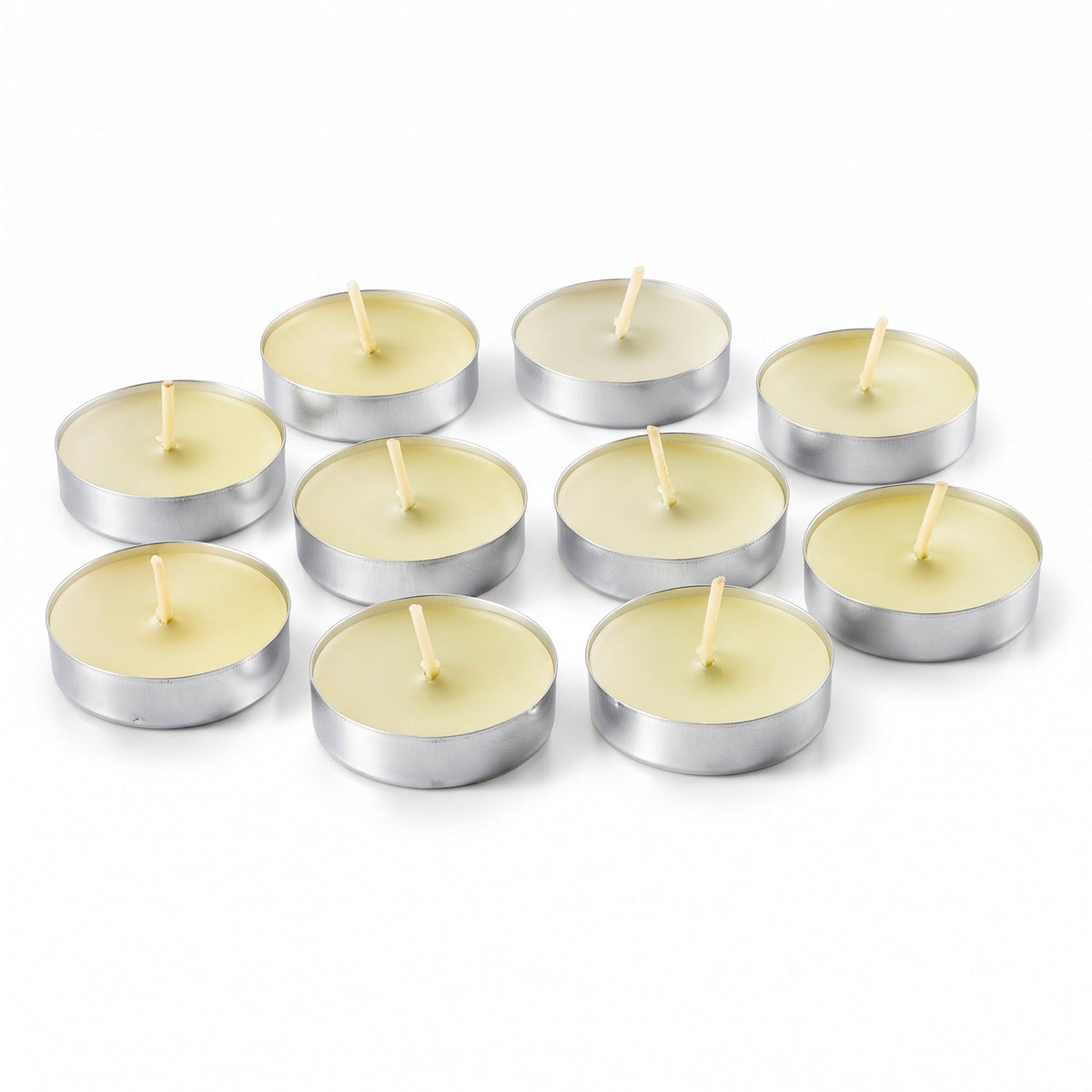 Ten unlit tea light candles with white wax and wicks, arranged on a plain white surface.