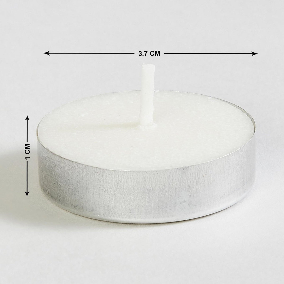 A single white tea light candle with dimensions of 3.7 cm width and 1 cm height.