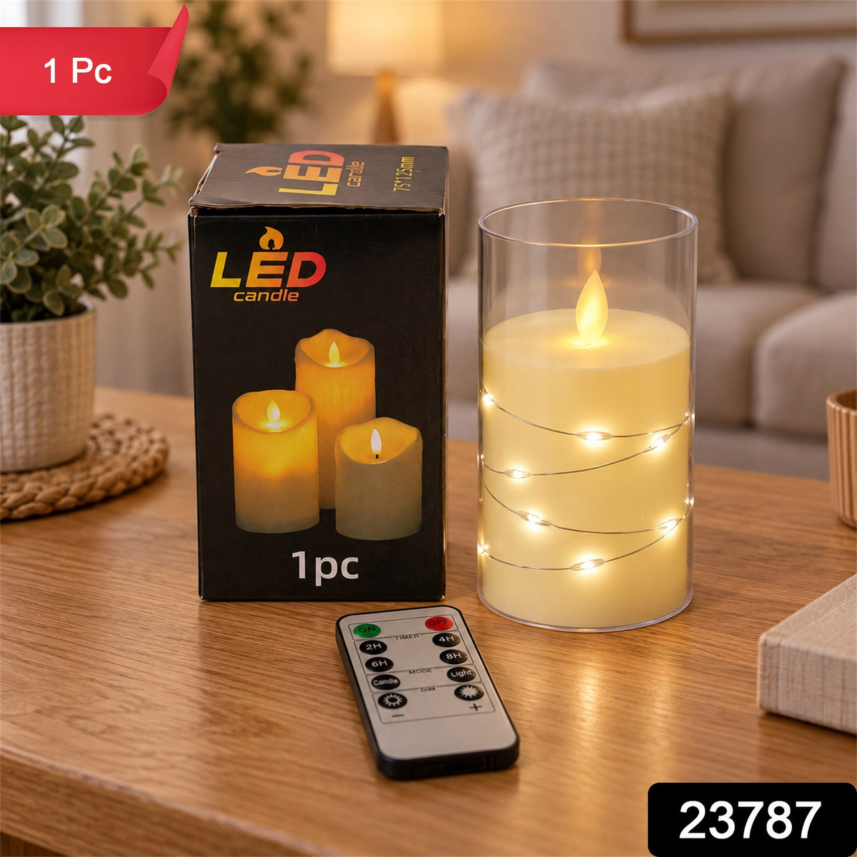 A hand holds the remote control, pointing it towards the LED candle in its glass cylinder, which glows warmly on a wooden