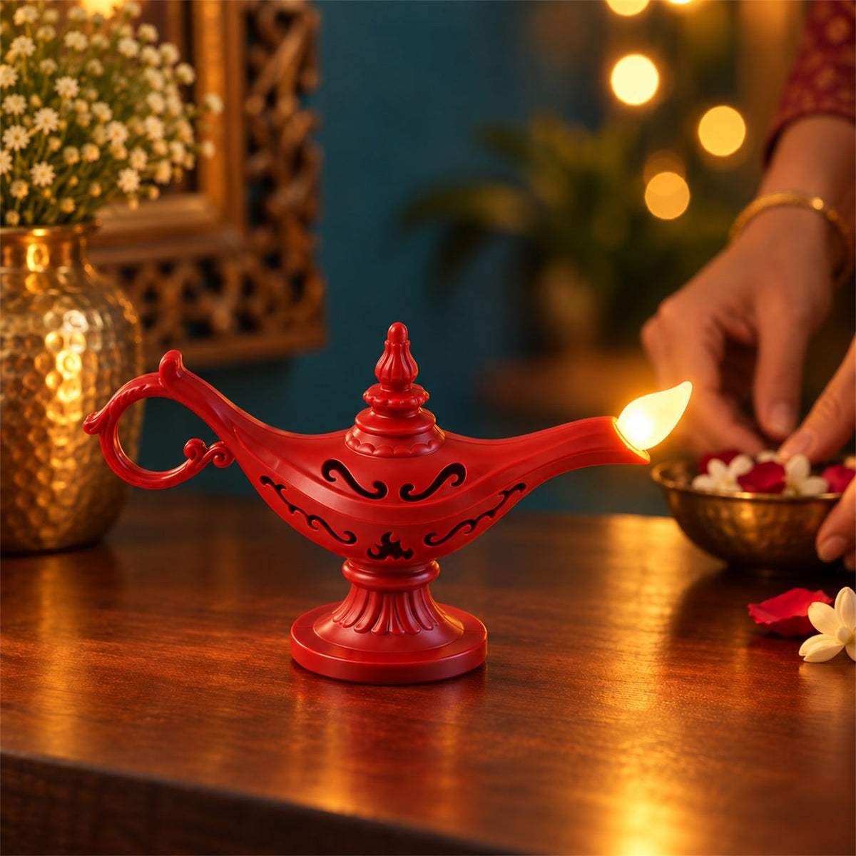 A red Aladdin's lamp LED light glows on a wooden table as a hand arranges flower petals in a small brass bowl.