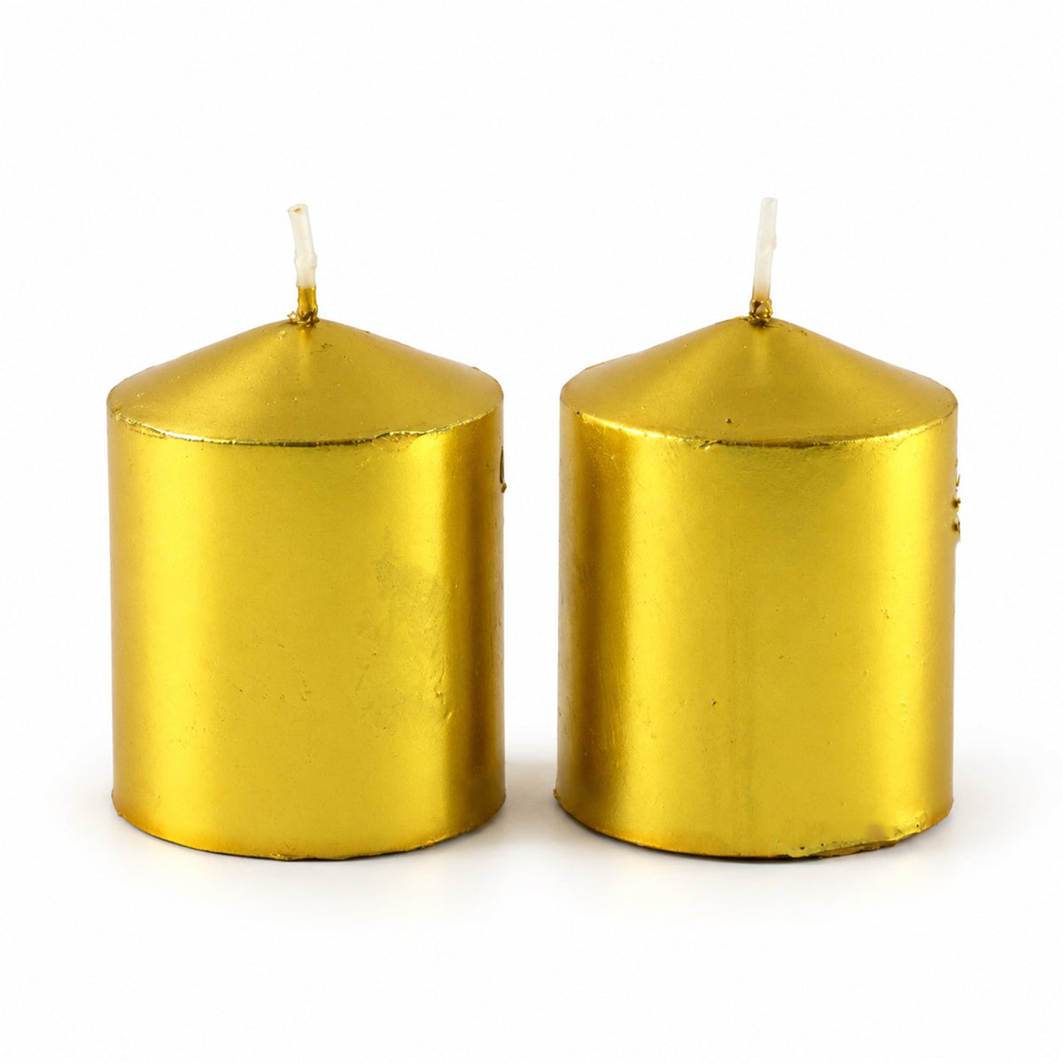 Two unlit golden metallic pillar candles with white wicks against a plain white background.