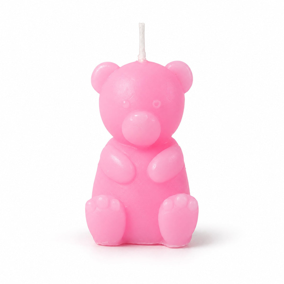 A pink teddy bear shaped candle with an unlit wick stands upright on a plain white background.