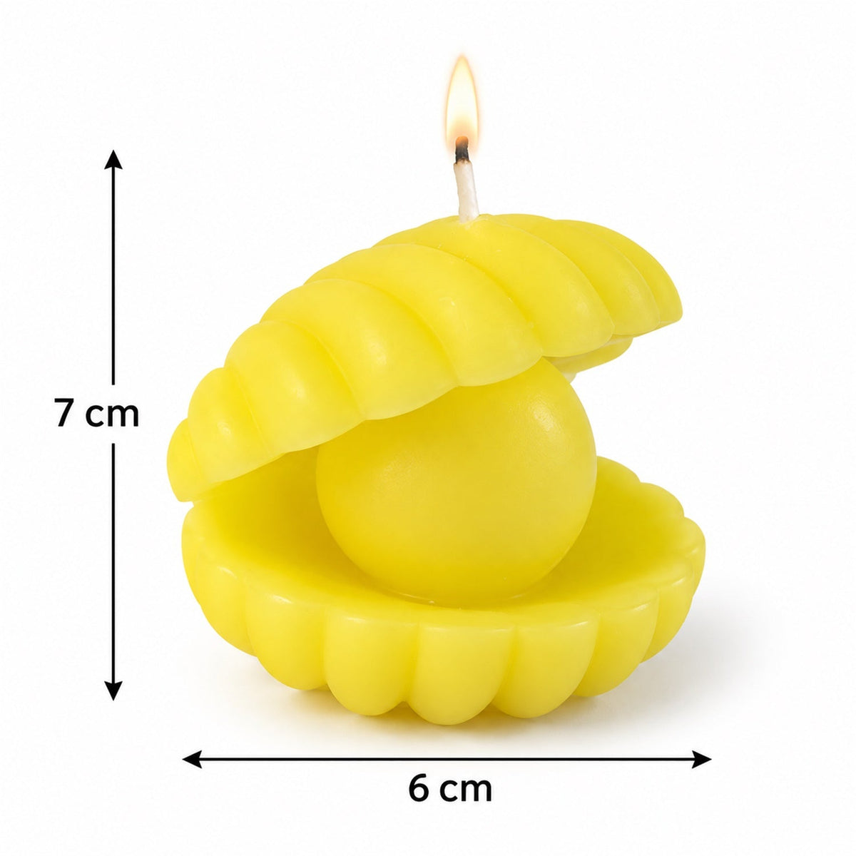 A yellow shell candle with a pearl center and lit wick is shown with measurement arrows indicating 7 cm height and 6 cm