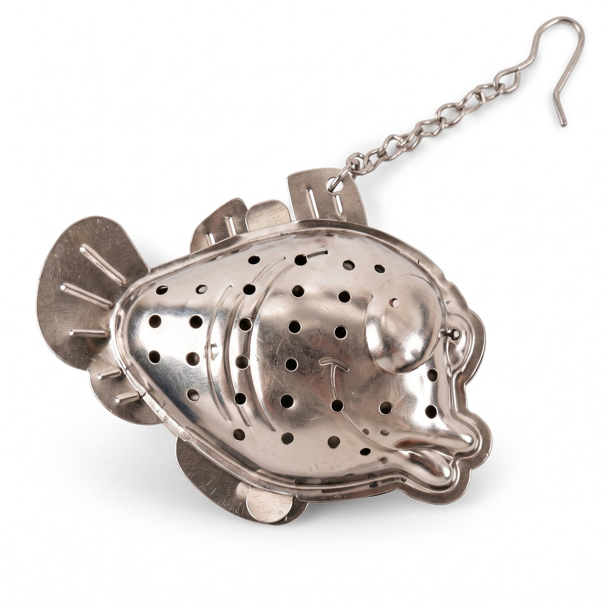 A close-up of a silver fish-shaped tea infuser with a chain and hook, against a plain white background.