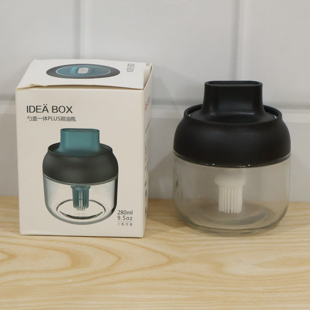 Live photo of round jar oil dispenser with colour box