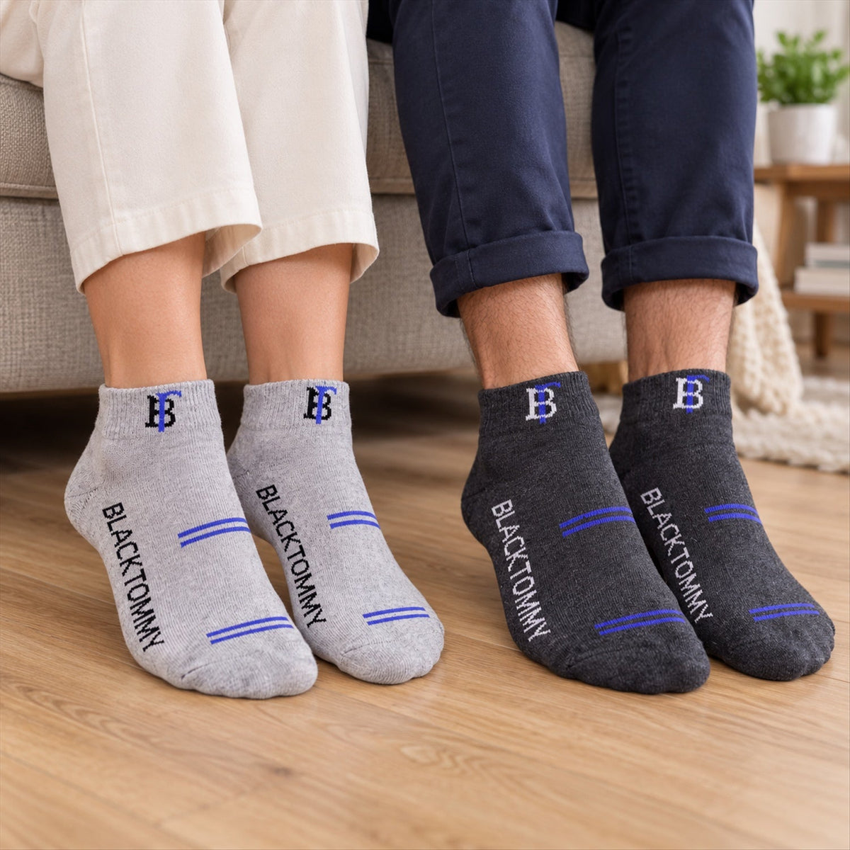Two people wear different colored ankle socks, one pair grey with blue stripes, the other charcoal with blue.