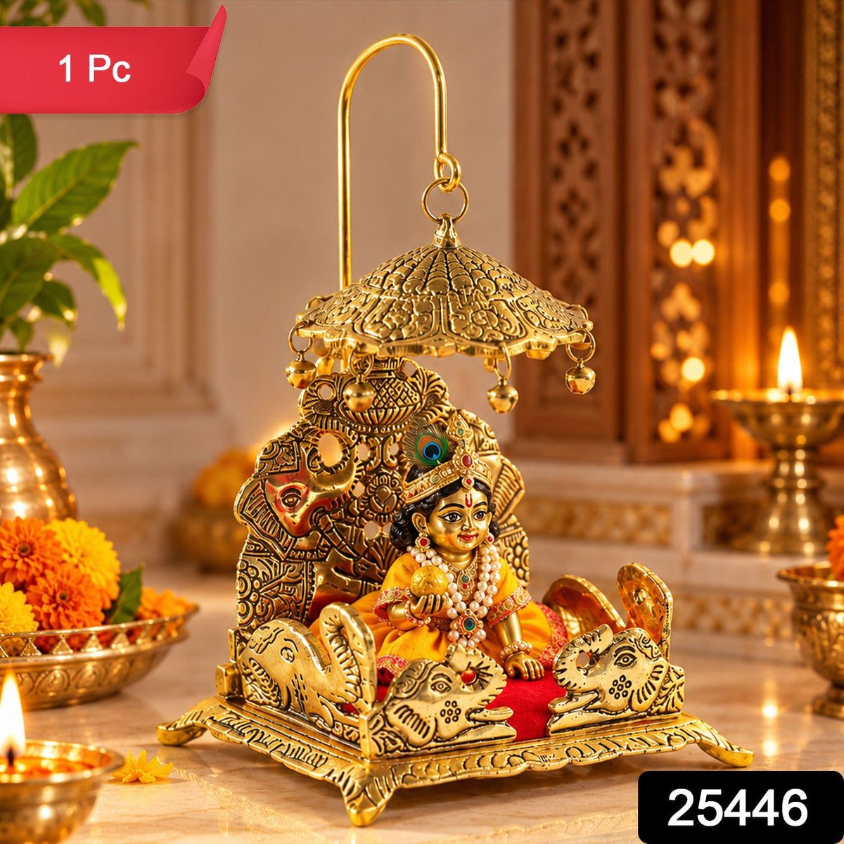 A detailed gold-colored brass deity throne with a red velvet seat, featuring a small Krishna idol and elephant motifs.