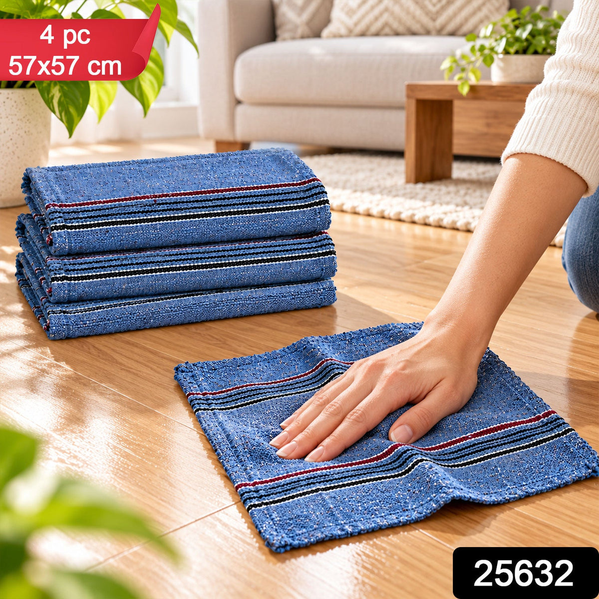 A hand cleans a wooden floor with a blue cloth, three folded cloths are stacked beside it.