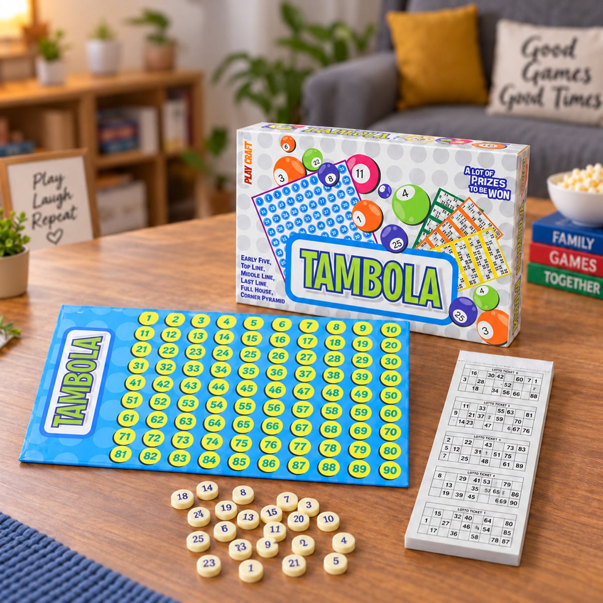 A Tambola game set, including a blue number board, small yellow number tokens, a booklet of tickets, and the game box, sits