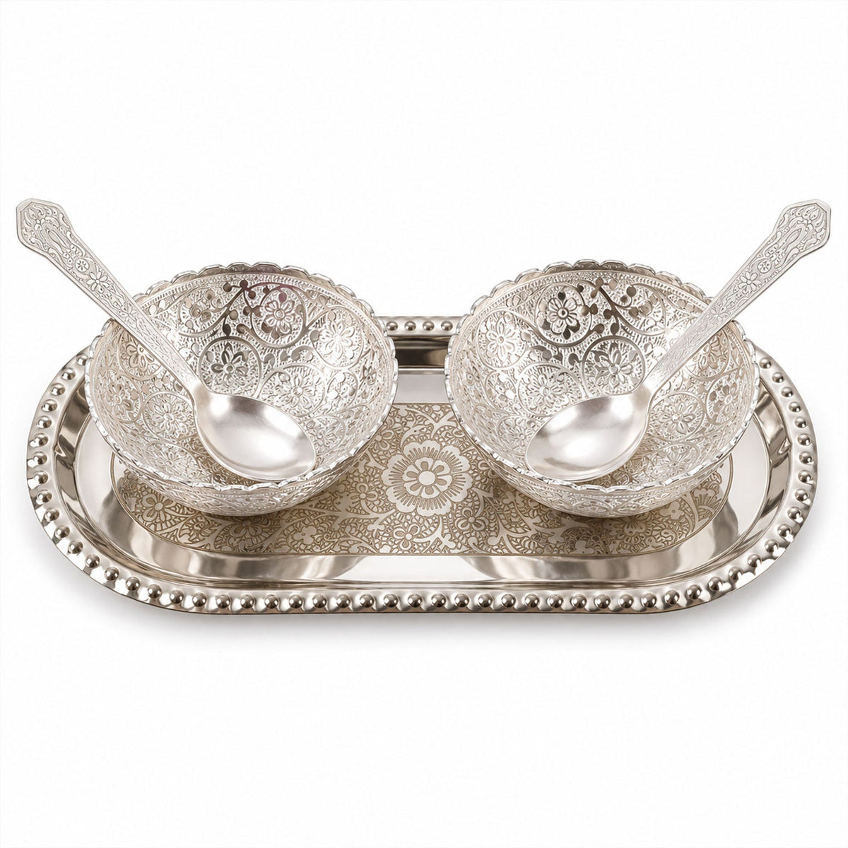 A silver-plated serving set with two decorative bowls and two spoons resting on an oval tray, against a white background.