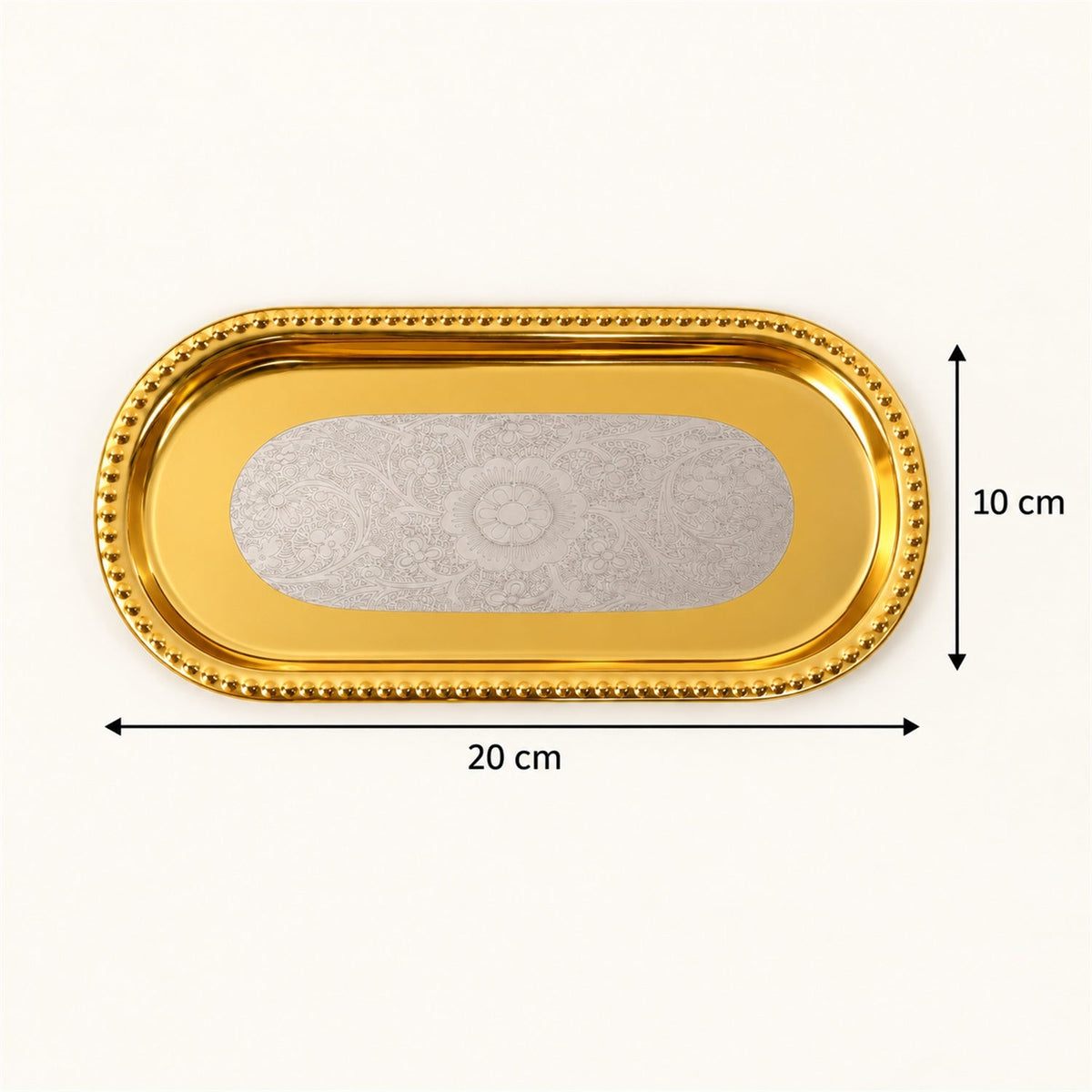 A golden oval tray with a silver floral pattern, showing dimensions of 20 cm length and 10 cm width.