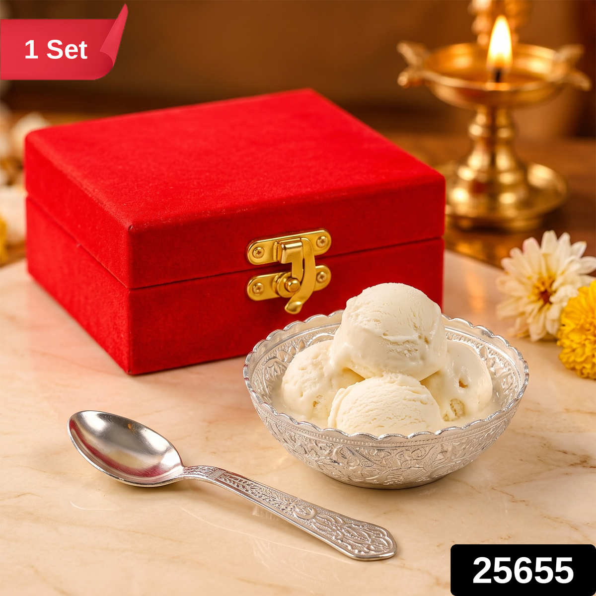 Silver finish floral bowl with ice cream, a matching spoon, and a red velvet gift box on a marble surface.