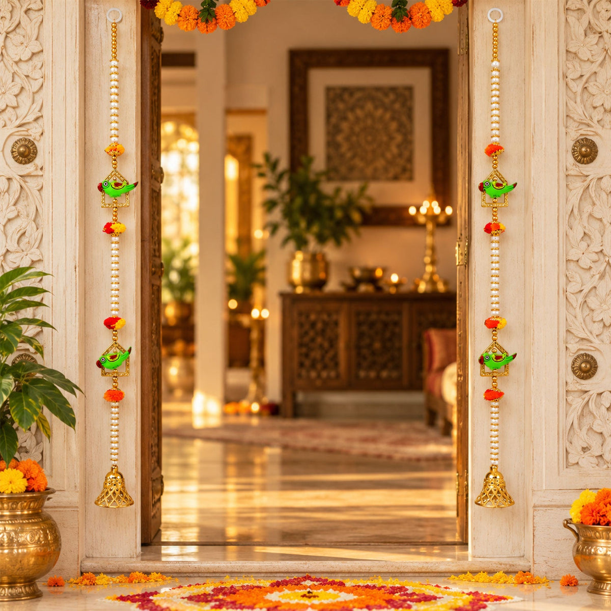 Two decorative door hangings with green parrots and golden bells frame a doorway, with a marigold garland above.