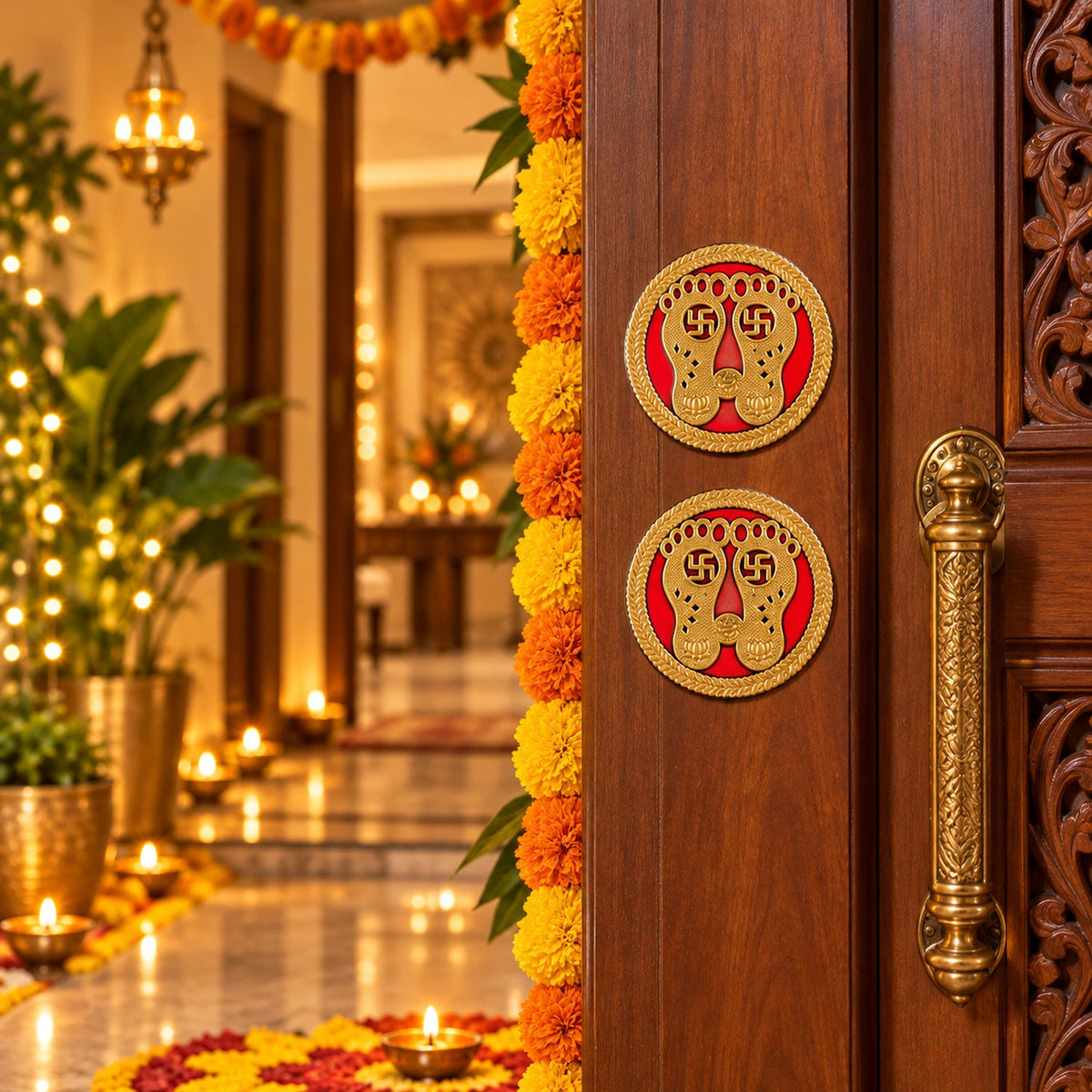 Two golden Lakshmi Charan stickers on a wooden door, surrounded by orange and yellow marigold garlands and glowing lights.