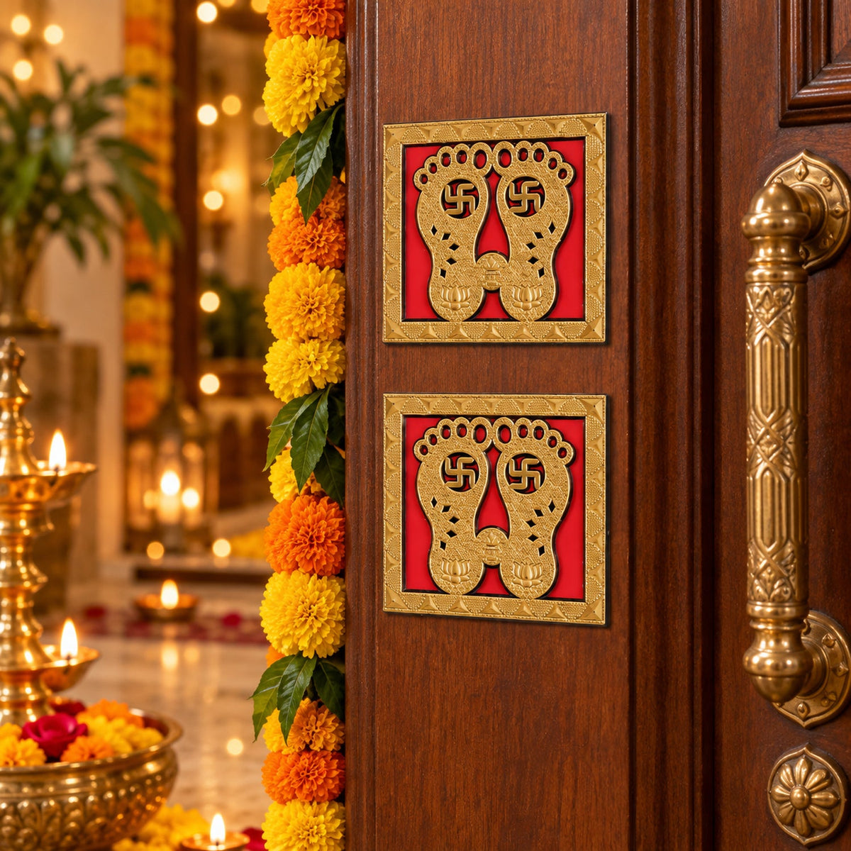 Two golden Lakshmi Charan stickers are placed on a wooden door, adorned with marigold garlands, with a festive home interior