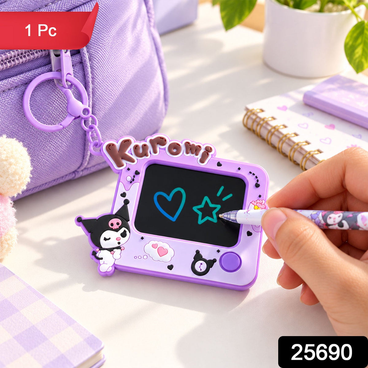 A hand draws on a purple Kuromi LCD writing tablet keychain, which is attached to a purple bag on a desk.