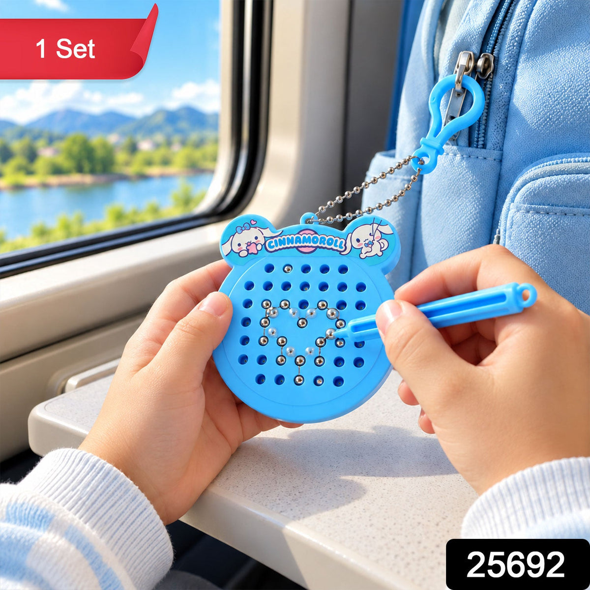 A child's hands hold a blue Cinnamoroll magnetic drawing pad keychain with a stylus, forming a heart shape on a – view 9